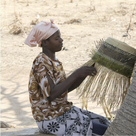 A Ghana Bolga basket weaver.  African basket weavers preserve their cultural heritage while they support themselves and their families.